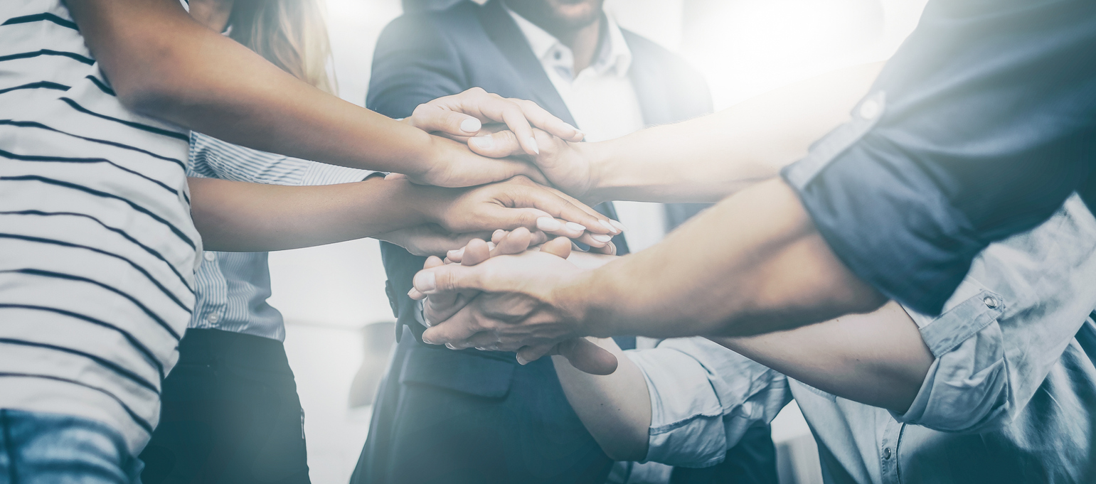 Group of people with their hands in a circle