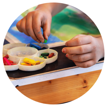 Close up on child's hands painting