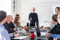 Group of coworkers sitting around a table in a training about bias